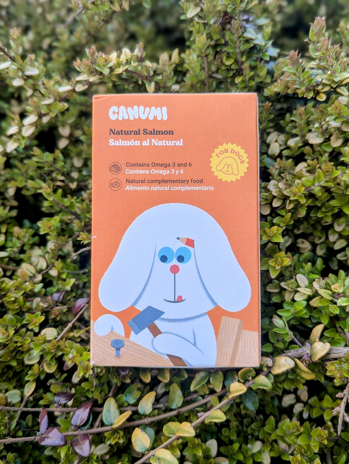 A packaged product of Canumi Natural Salmon, featuring an illustration of a dog on the front.