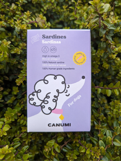 A package of Canumi Atlantic Sardines placed against a leafy background, highlighting the product as pet food.