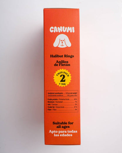 A tall orange rectangular box for Canumi Halibut Rings, featuring a white dog logo, black text, and a yellow circular badge indicating a twin pack of 2 pieces.
